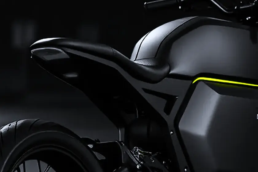 The seat and bare tail of Vaayu Zero, no number plate mount, a lime line along the tank below.